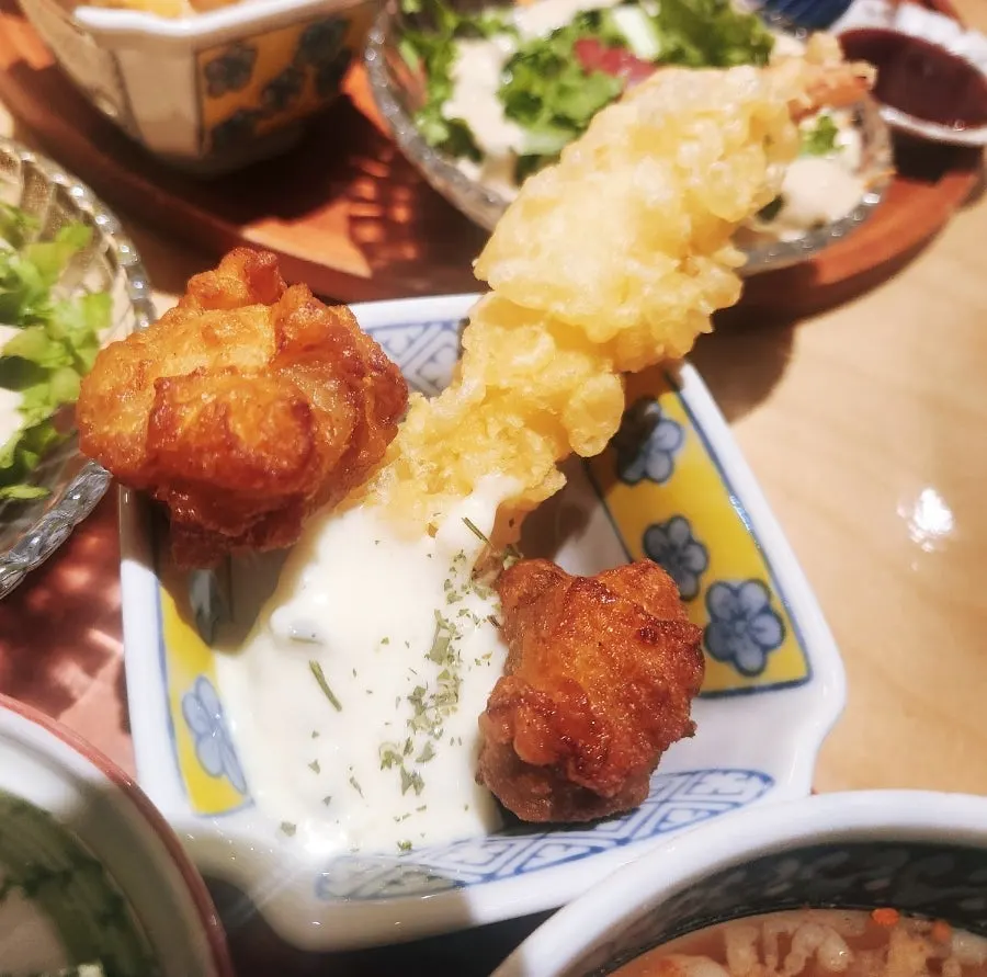Table with sushi and side dishes laid out together