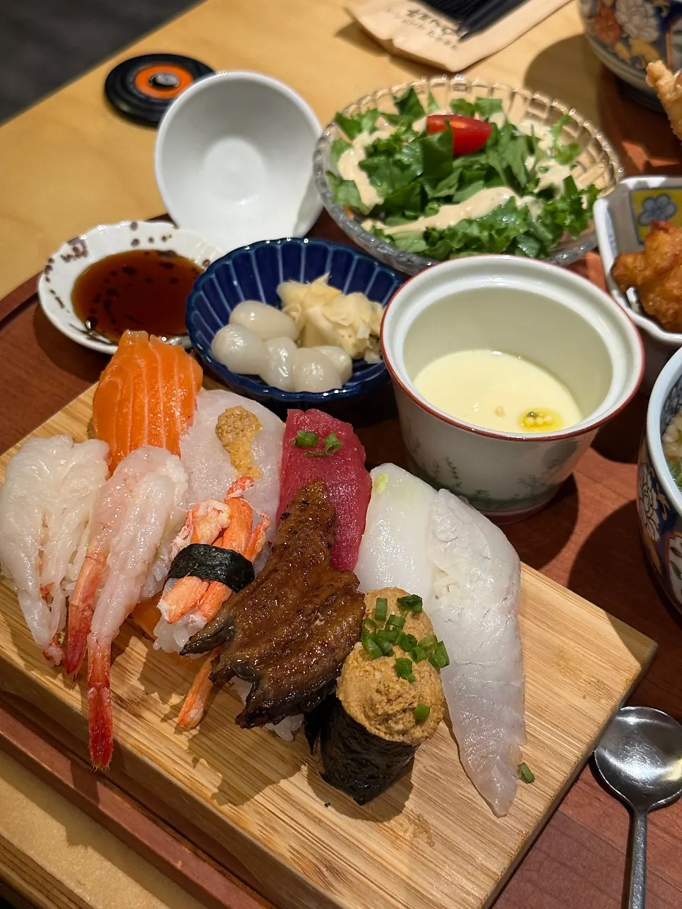 Sushi lineup including halibut, red seabream, and salmon