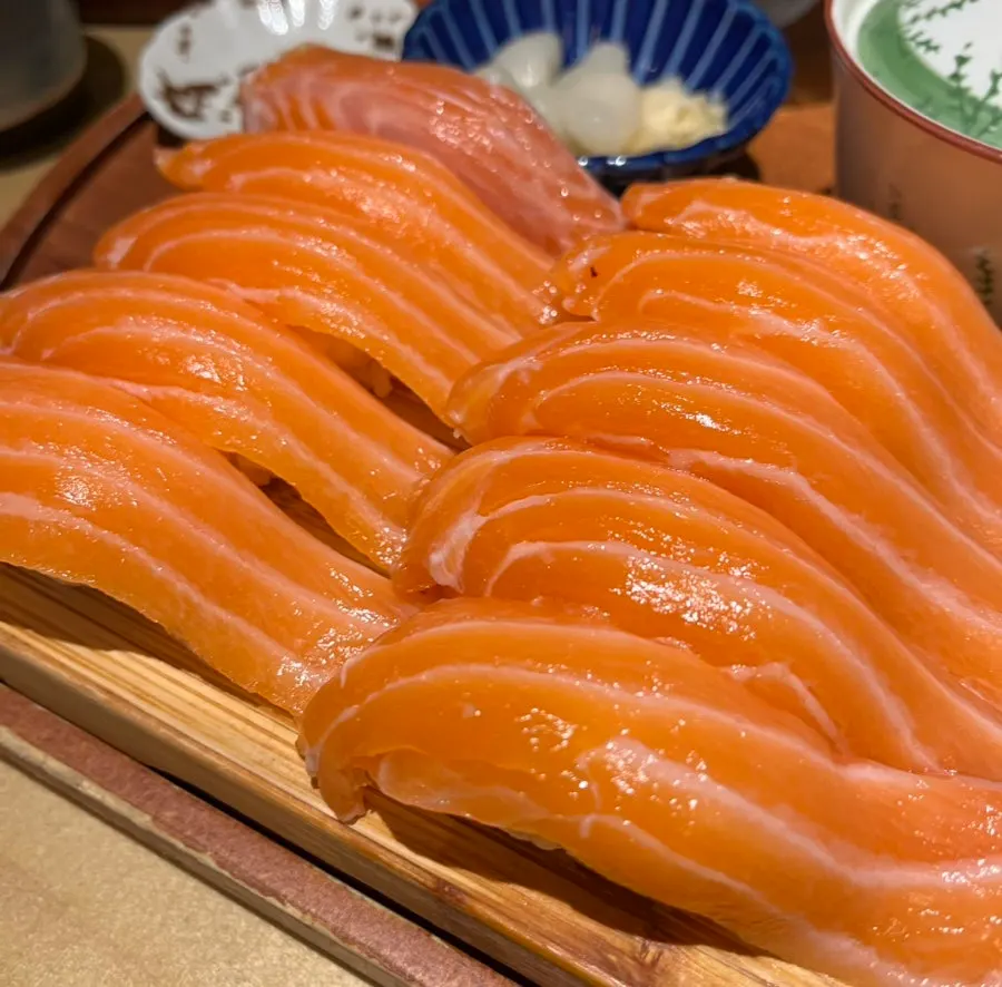 Thick salmon sushi set on a wooden cutting board
