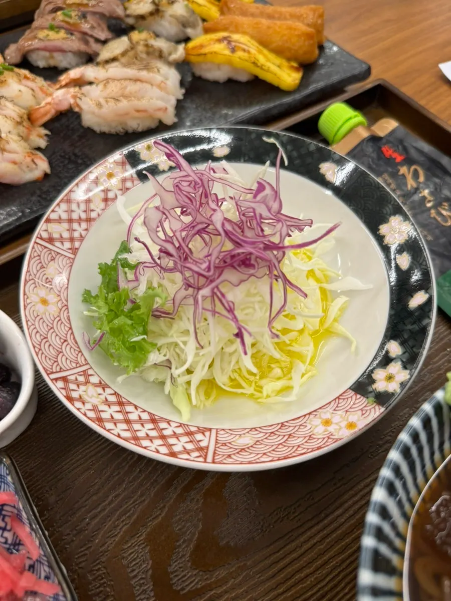 An individual spread with side dishes, salad and cold buckwheat noodles