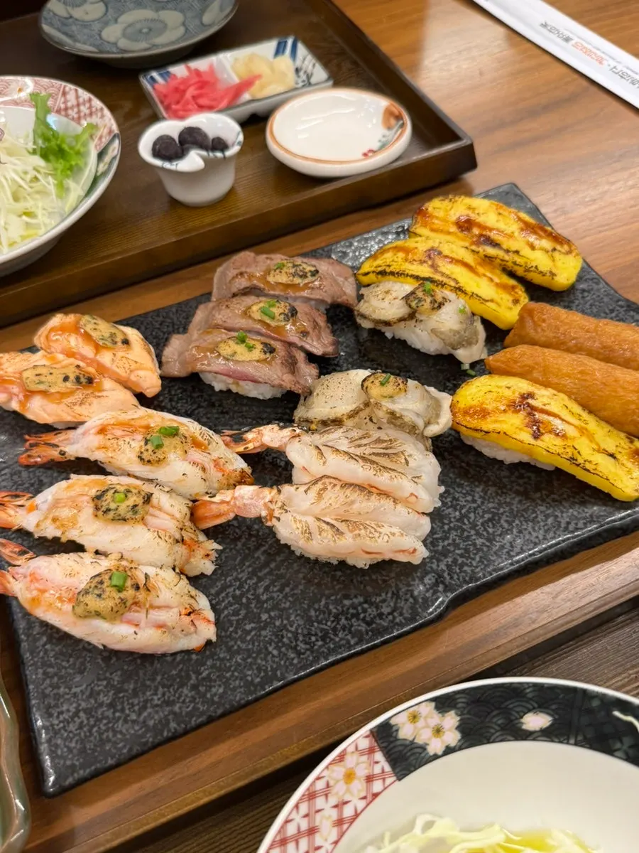 Flame-seared sushi topped with spicy sauce
