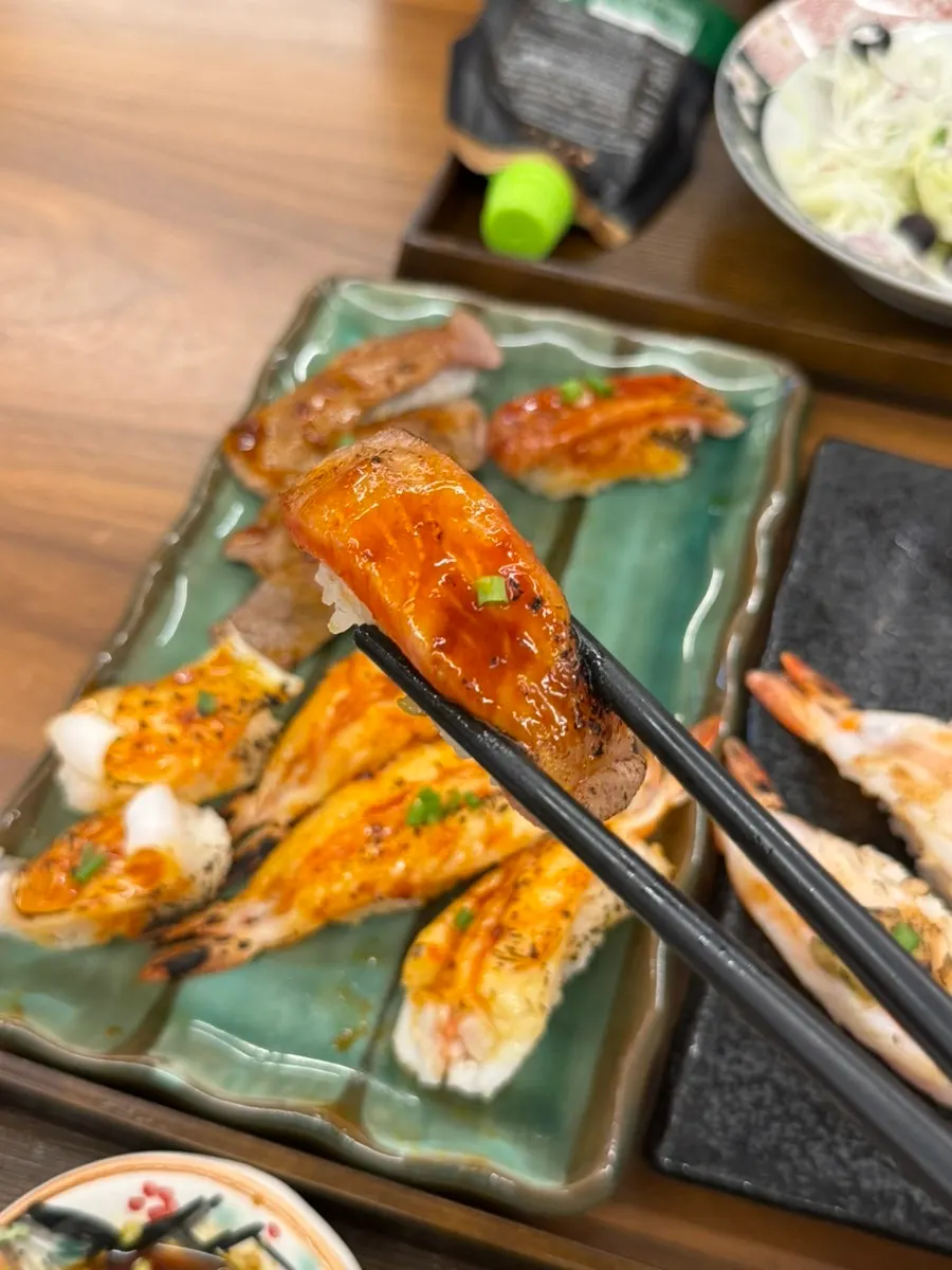 A flame-seared sushi selection including shrimp