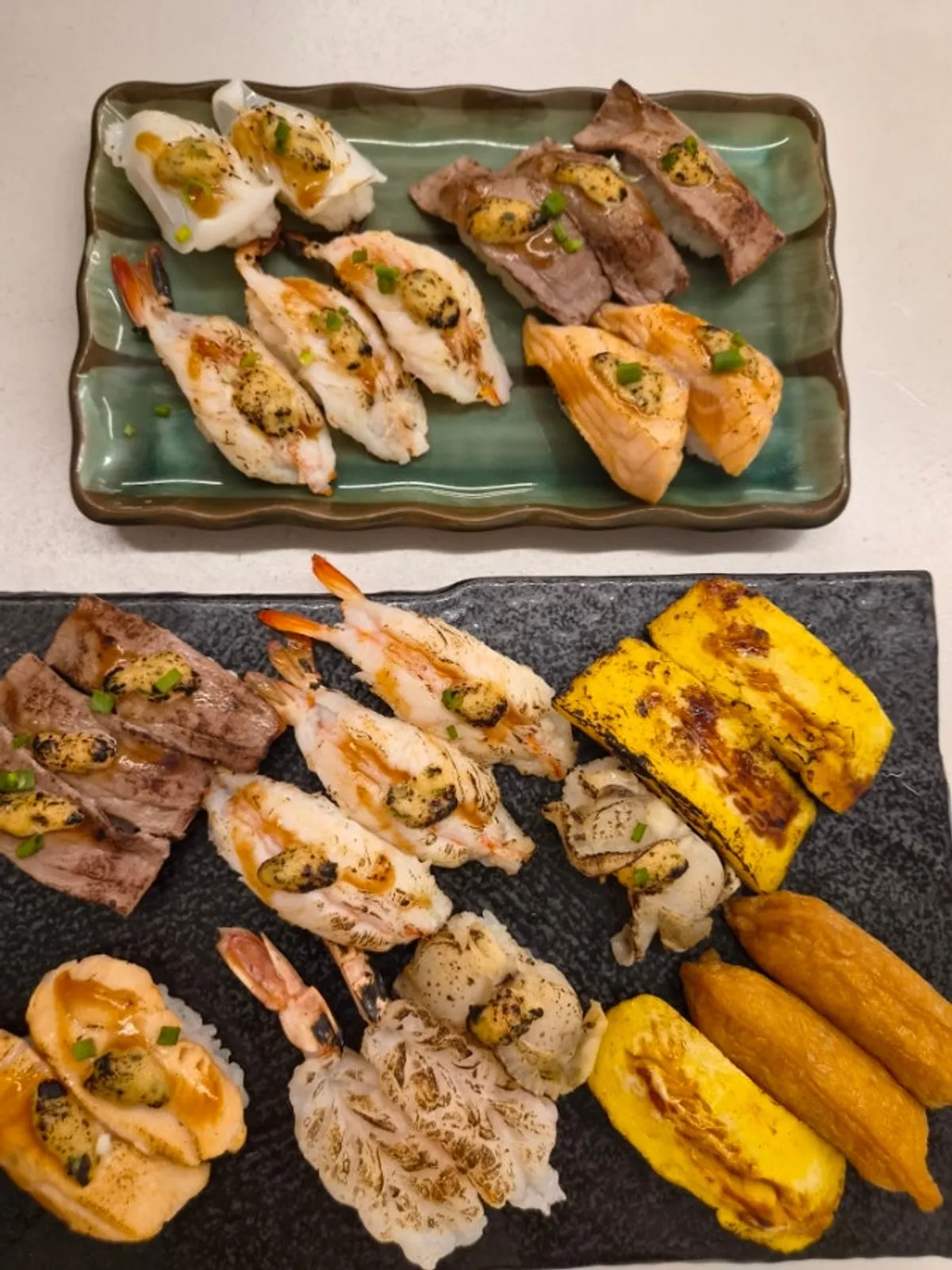 A plate of 27 pieces of flame sushi filling the table