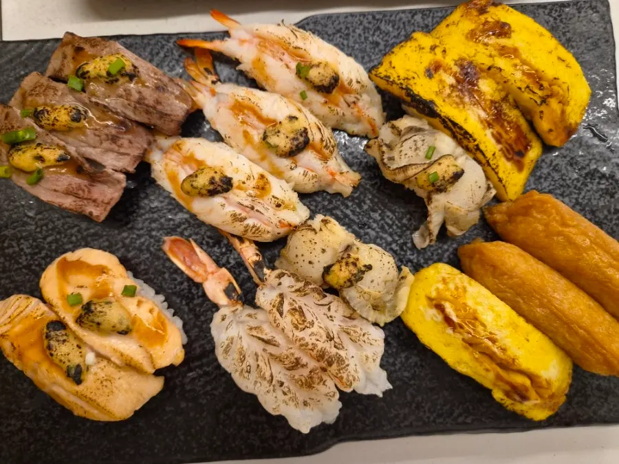 Sushi Hwa's flame sushi with wagyu, salmon, and other varied toppings