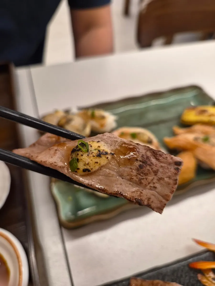 Picking up a piece of garlic sauce flame sushi