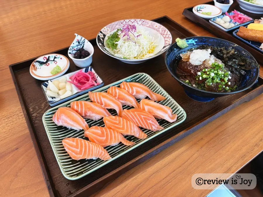 Mixed raw sushi lineup with shrimp, scallop, fried tofu, and more