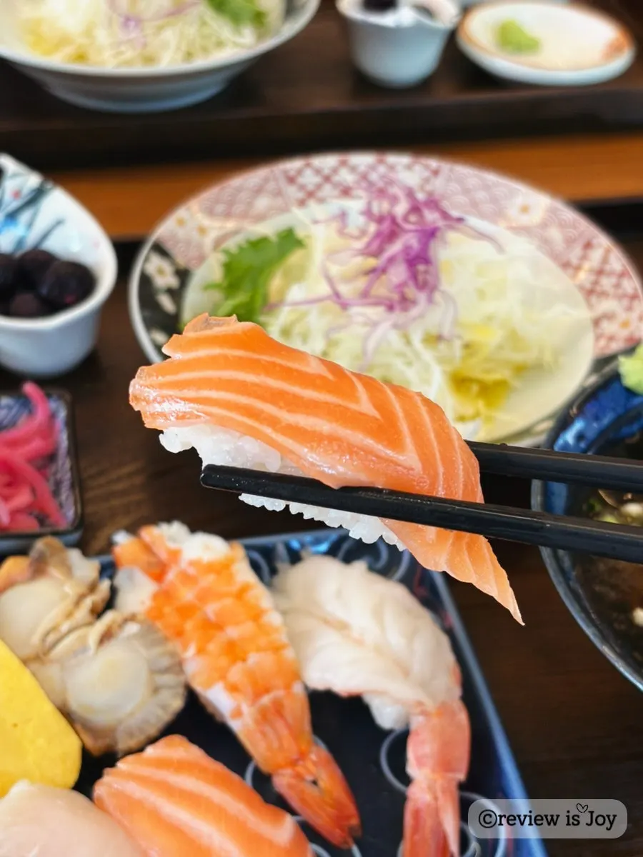 Raw sushi topped with a thick cut of fish