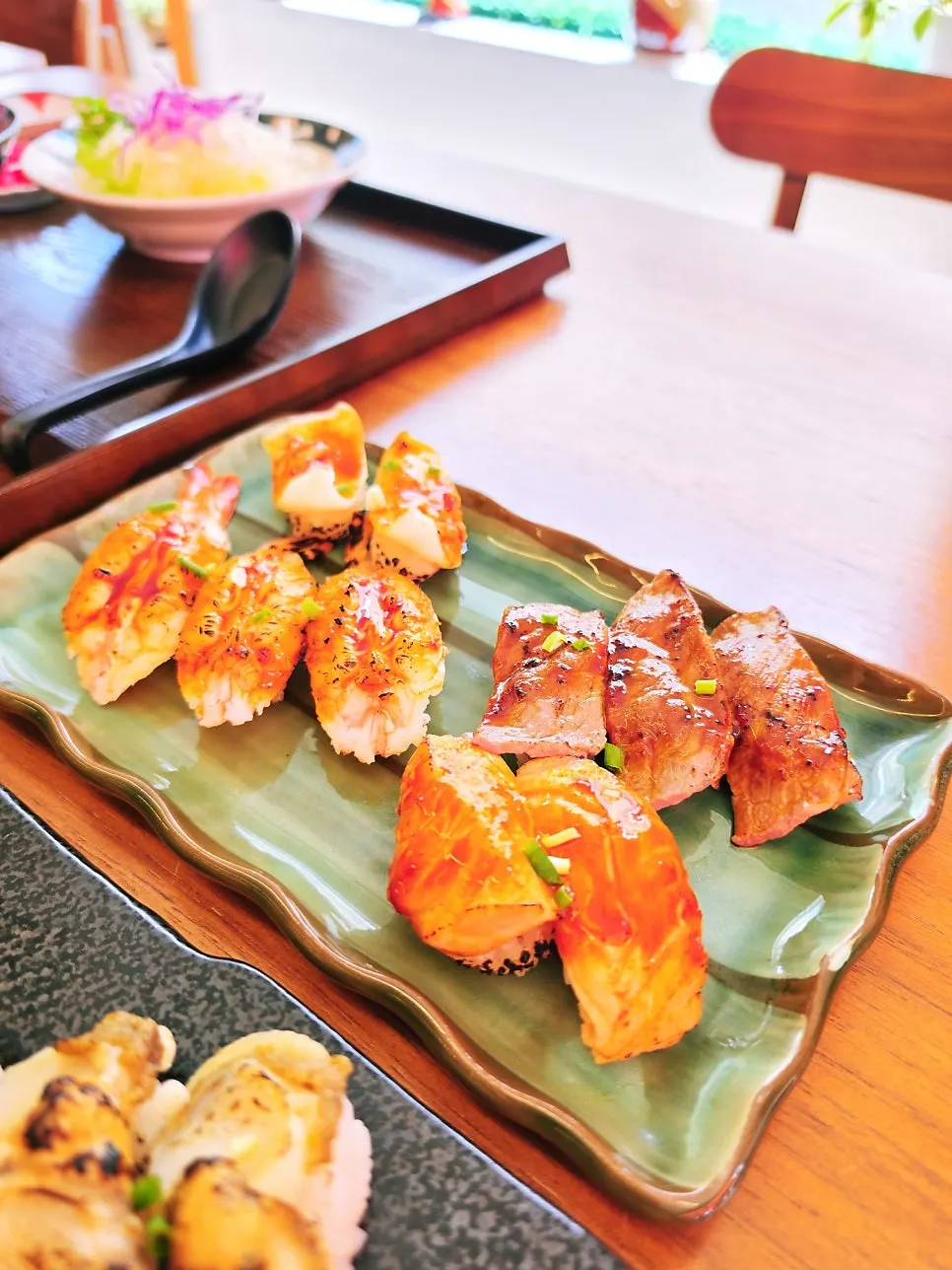Flame sushi topped with garlic and spicy sauce