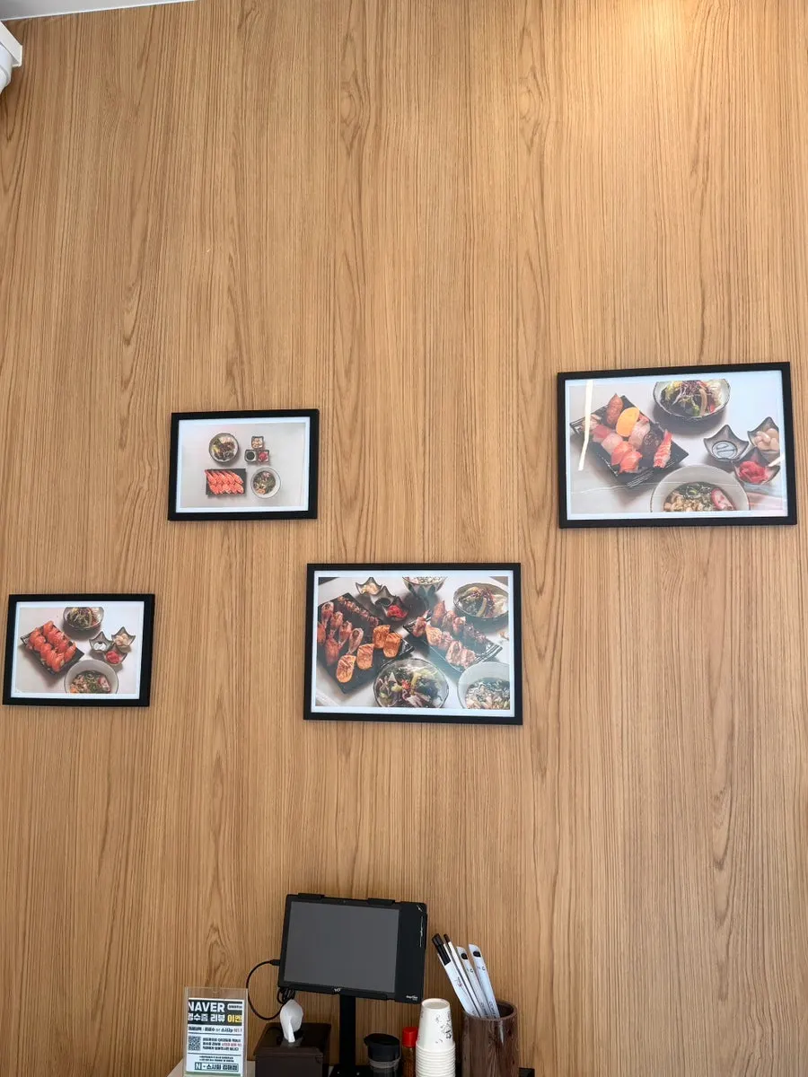 Sushi menu photos posted on the wall