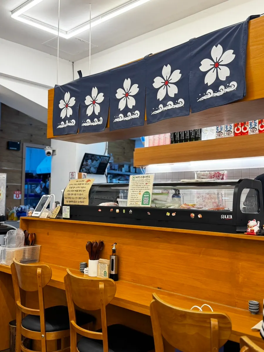 White and wood-toned interior of Sushi Naru