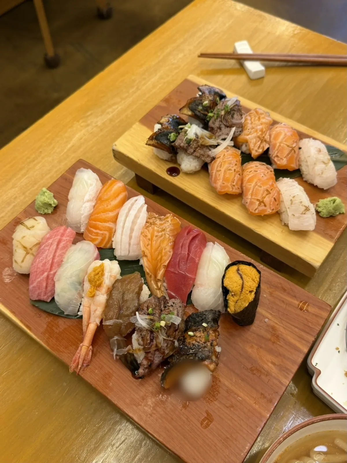 Two plates of Sushi Naru's Special Sushi and Grilled Assorted Sushi
