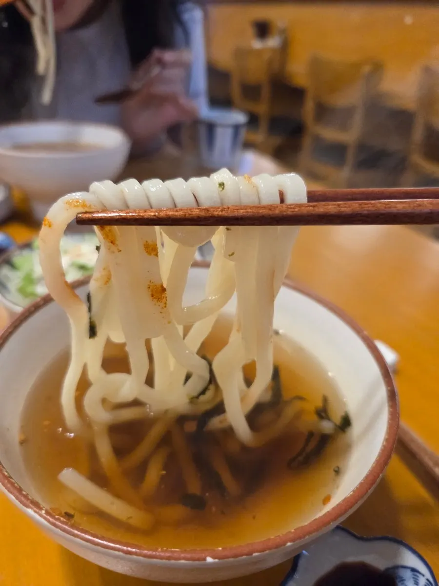 A meal of udon and sushi placed together