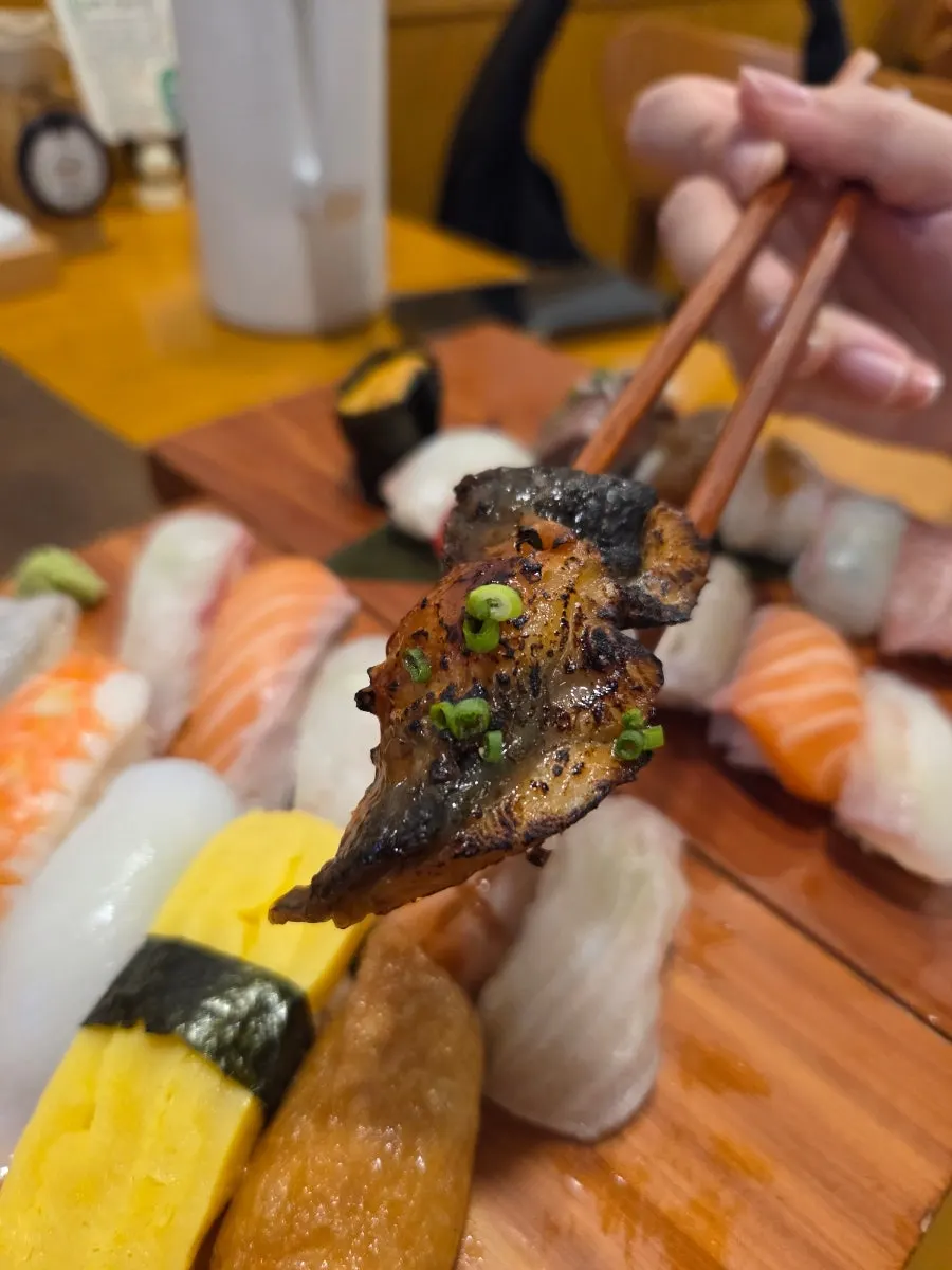 A piece of sushi with rice still warm