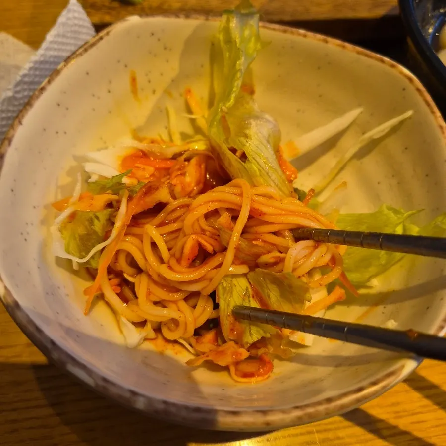 A bowl of tangy, spicy pre-meal bibim noodles