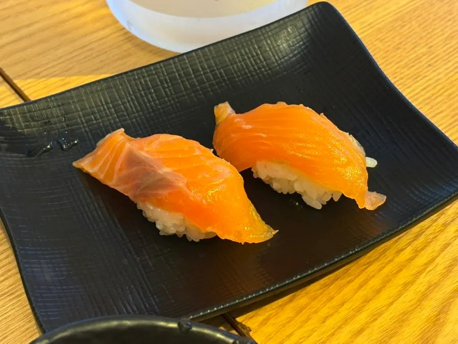 Two extra pieces of salmon sushi that were ordered