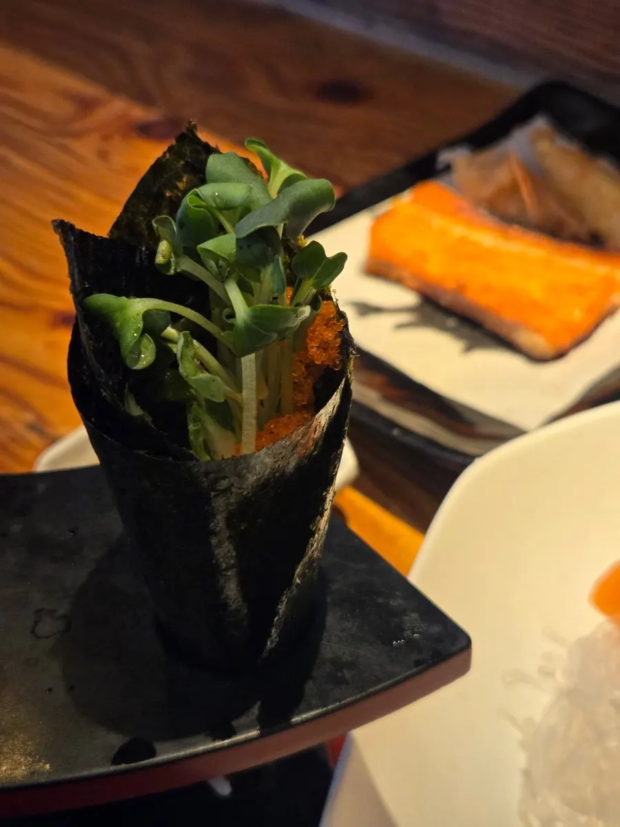 A full sashimi set spread with a bottle of soju