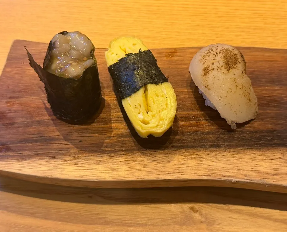 Additional sea urchin, eel, and salmon sushi