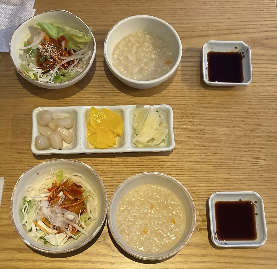 Starters including vinegar noodle salad, porridge, and pickled shallots