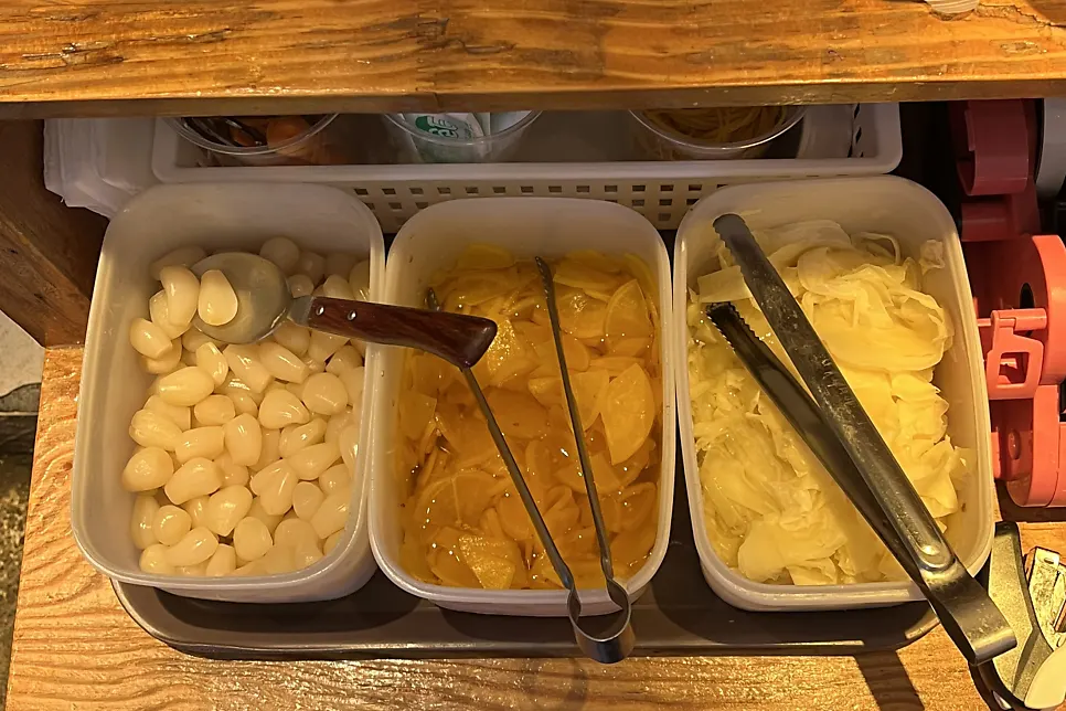 Self-refill station for pickled shallots, ginger, and radish