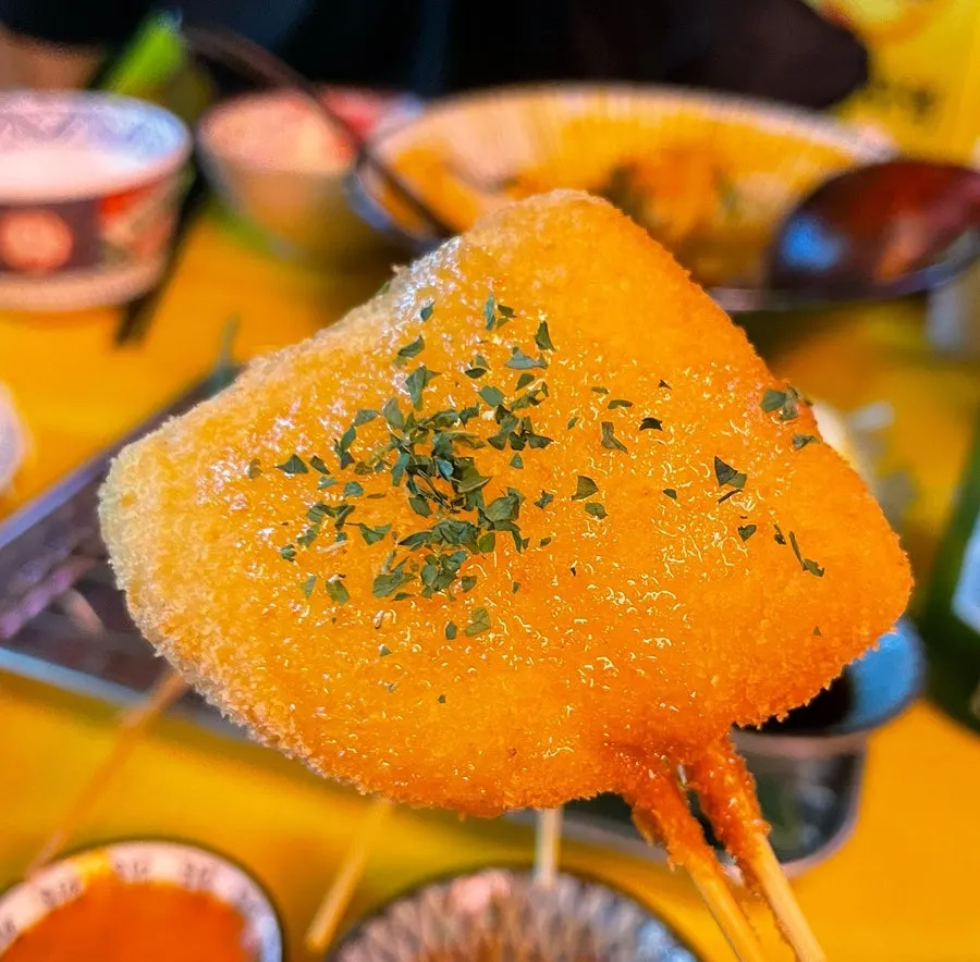 Kushikatsu dipped in sauce
