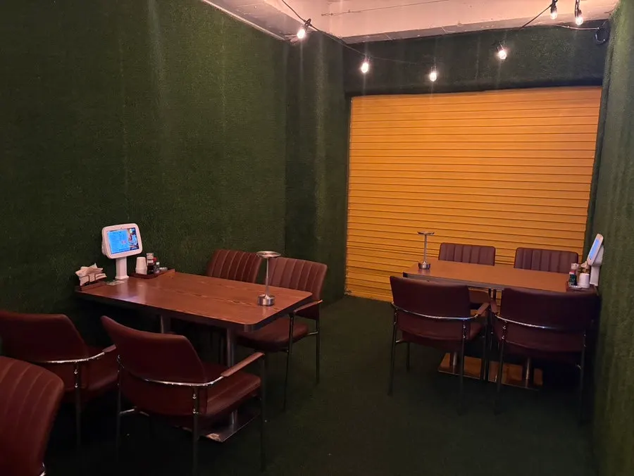 A small, room-like seating area next to the main space