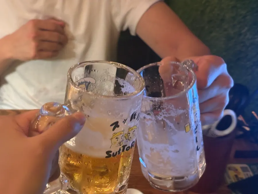 Clinking draft beer glasses in a toast