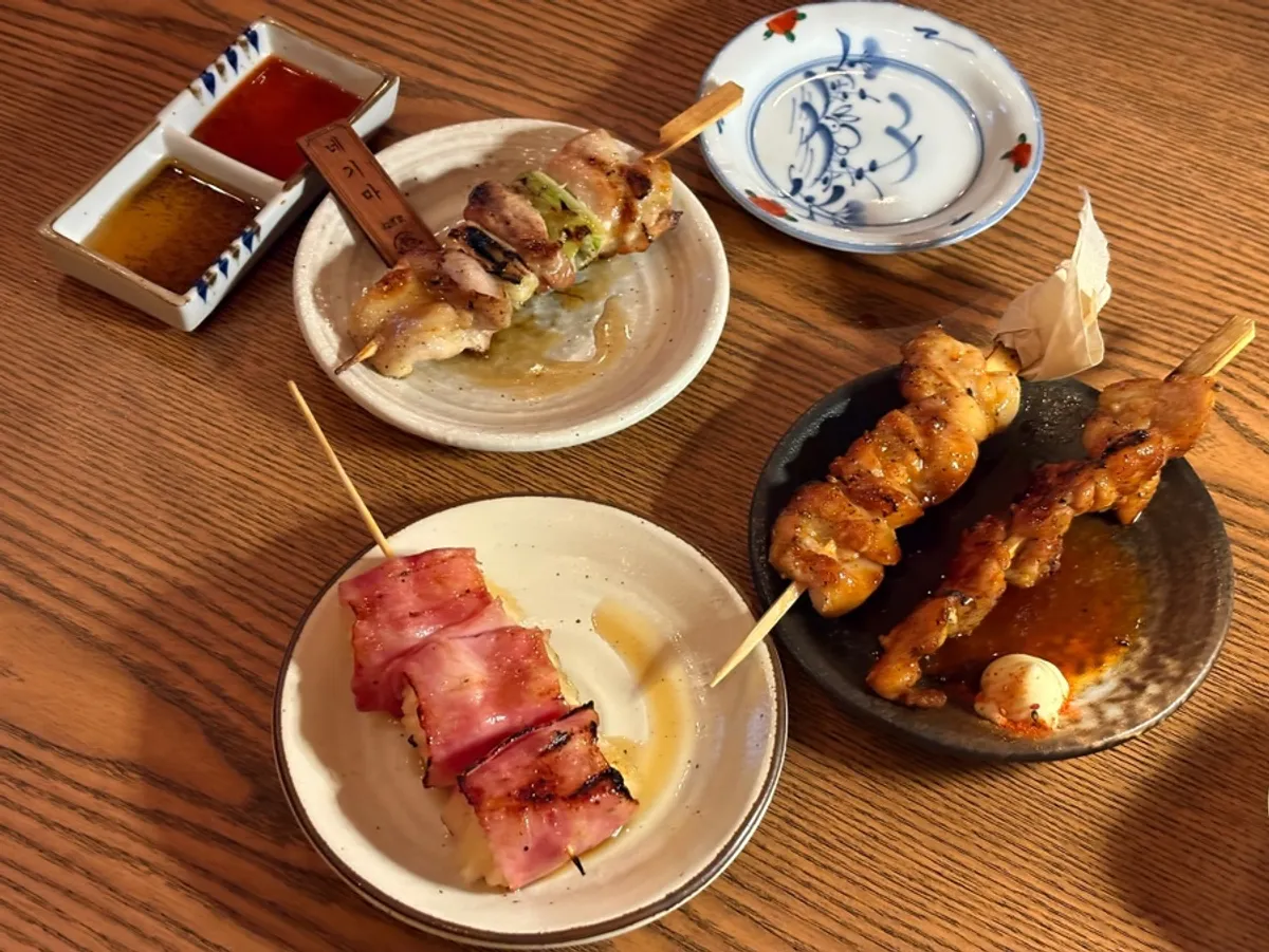 A spread of various skewers and draft beer for round two