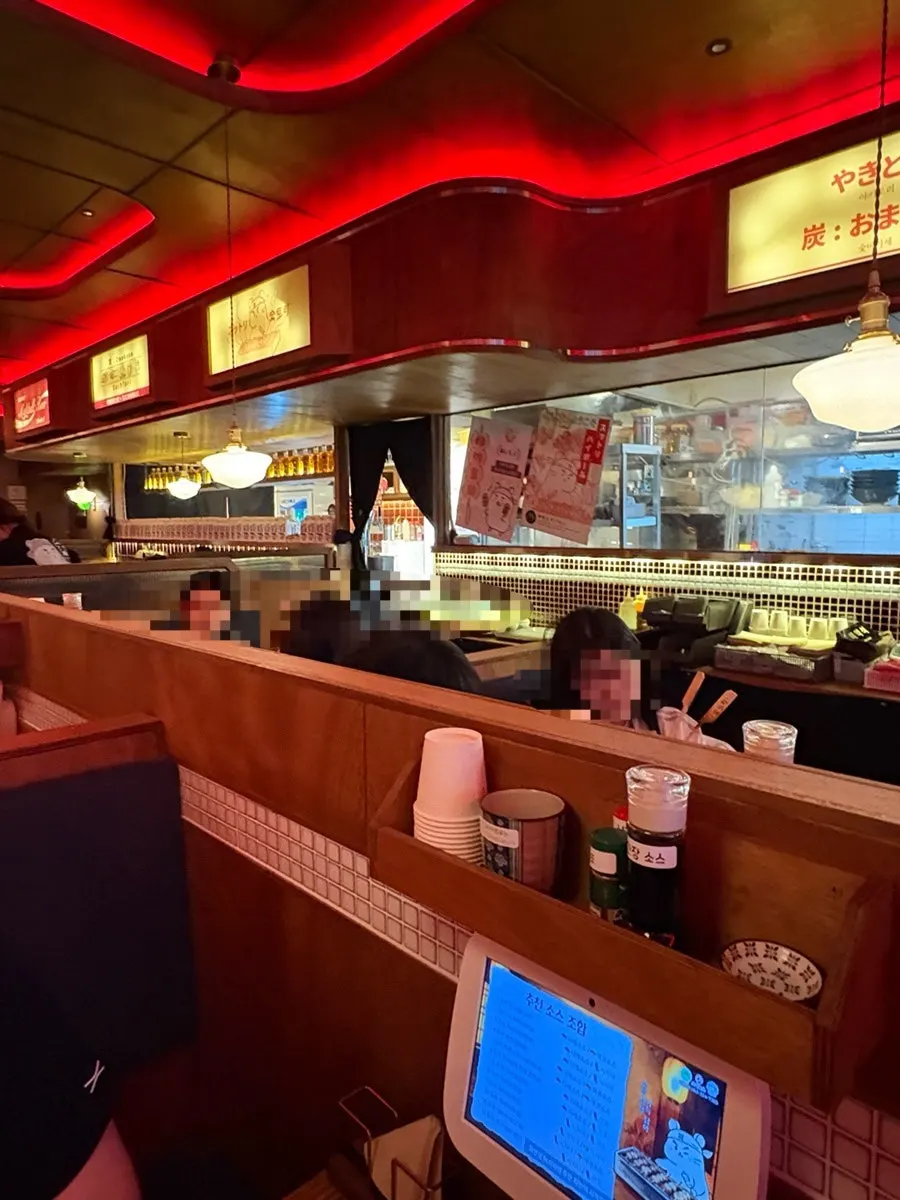 Izakaya interior with window and group seating