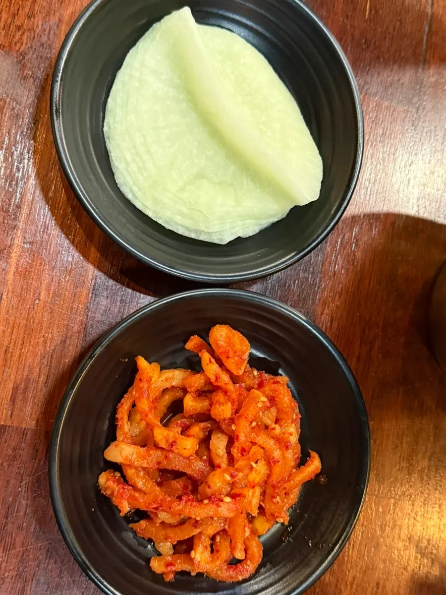 Dried radish namul, pickled radish, ssamjang, and salted shrimp side dishes