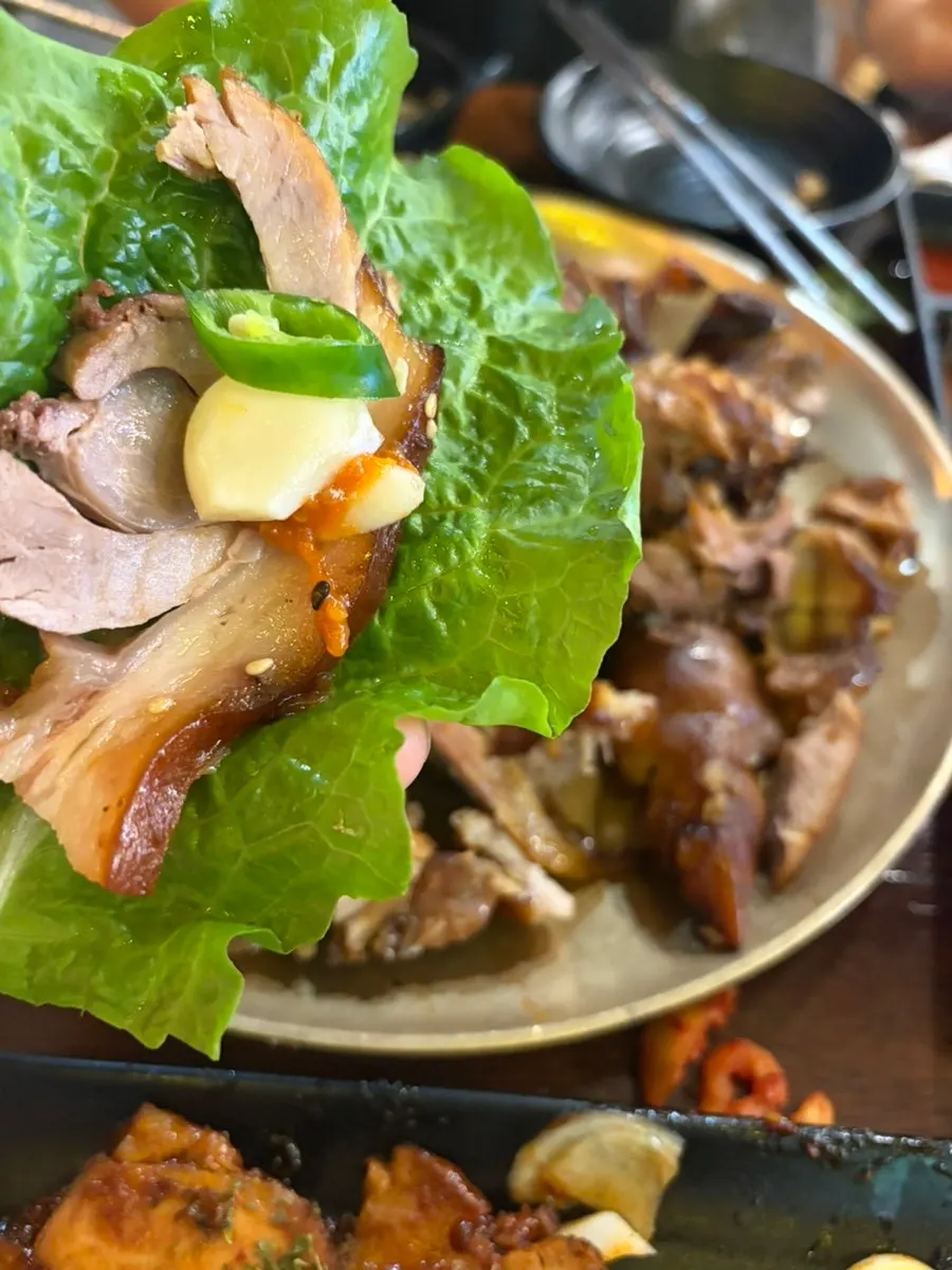Jokbal served in a lettuce wrap