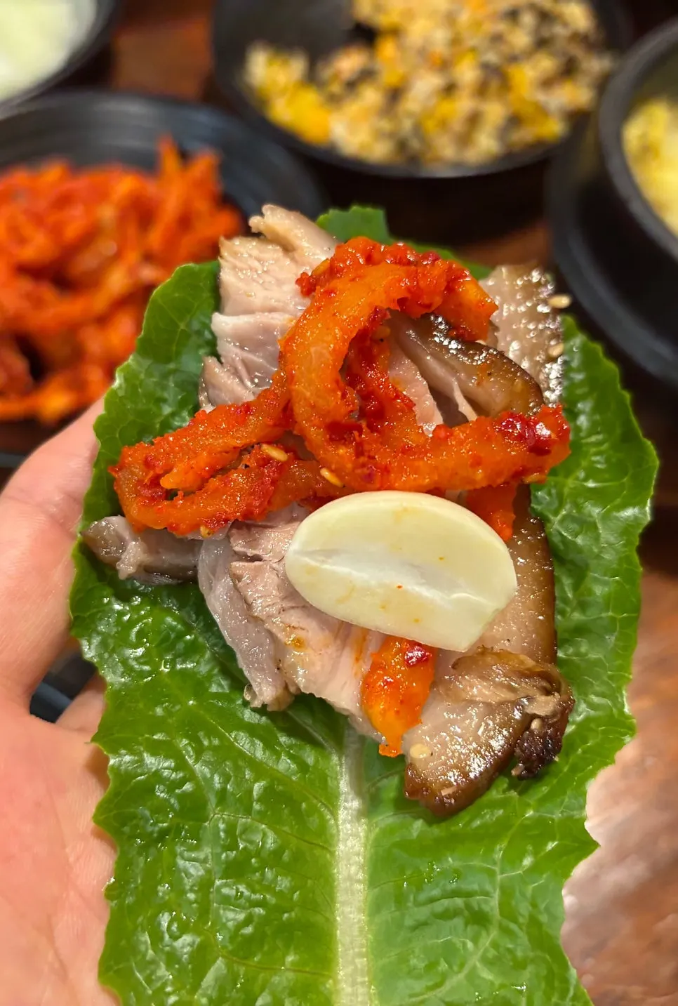 A piece of jokbal with pickled radish and dried radish strips