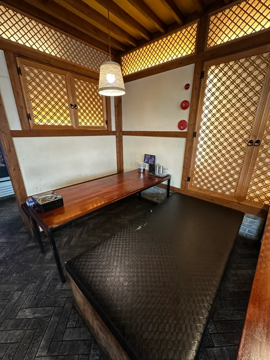 Spacious restaurant interior with a giant screen