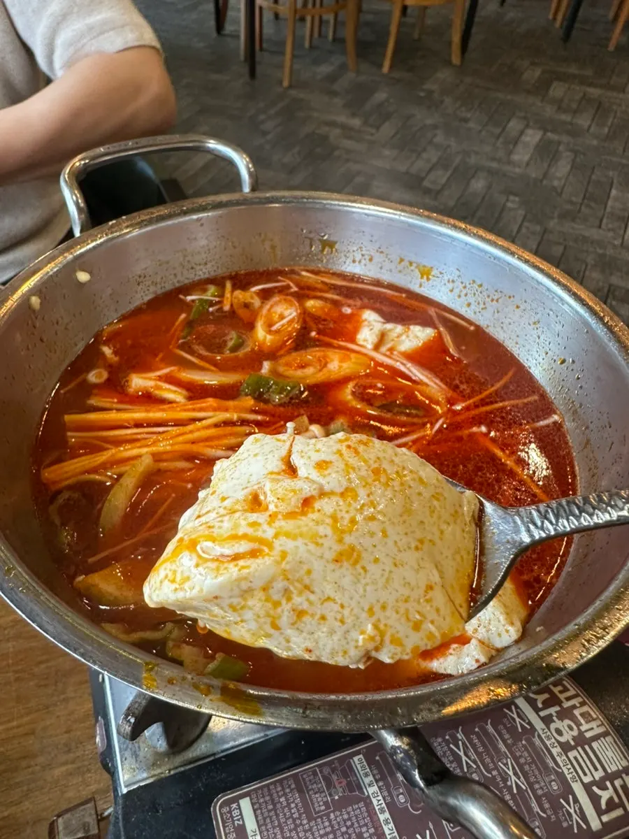 Soft tofu stew simmering with an egg