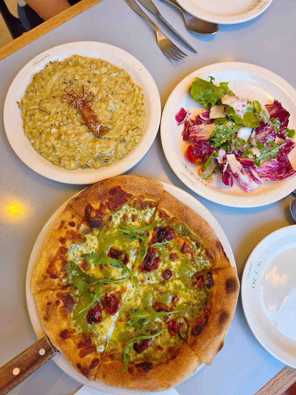 Pizza topped with cheese and arugula