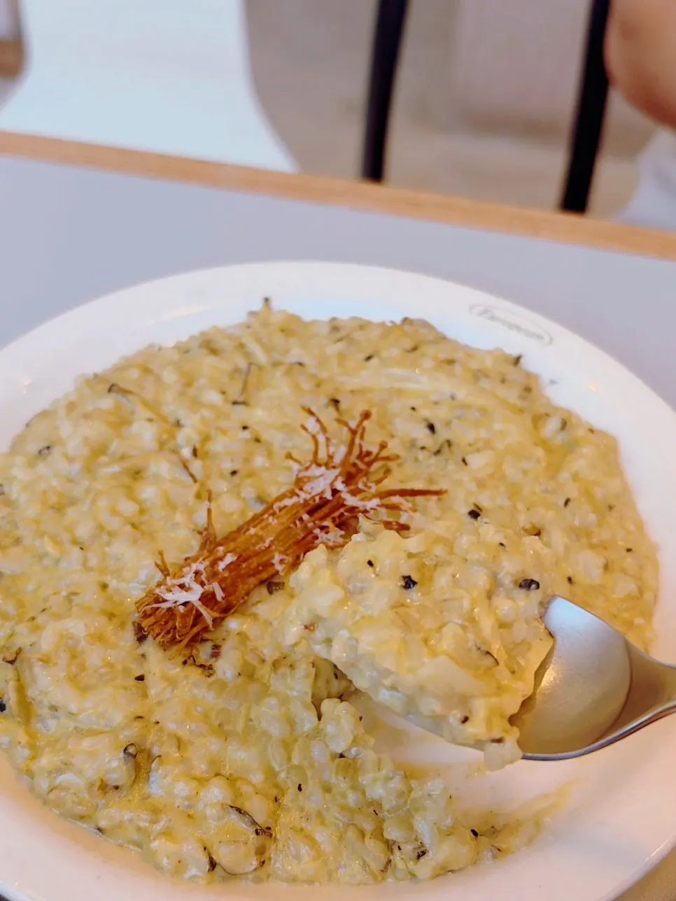 Risotto topped with fried enoki mushrooms