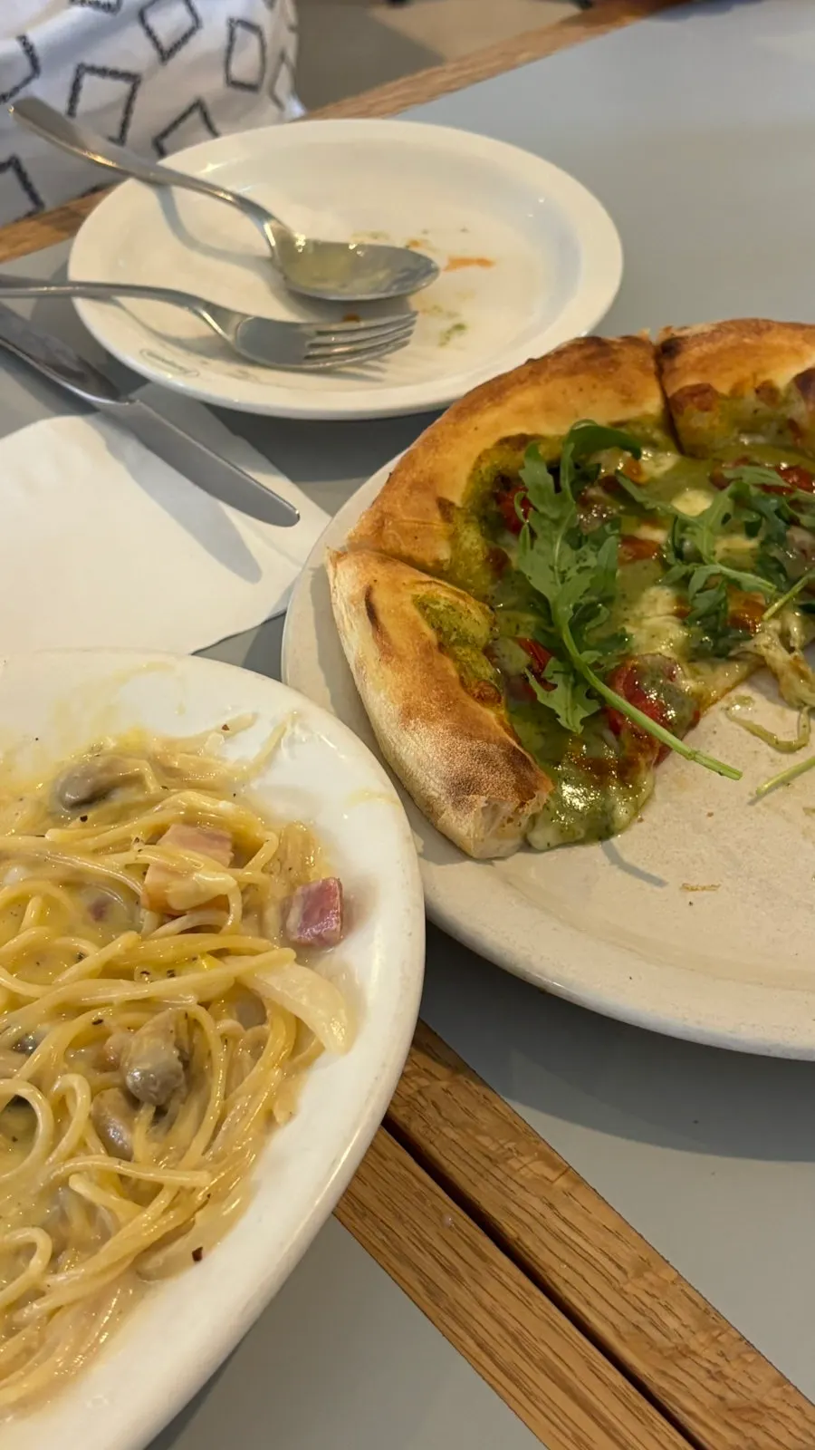 A spread of carbonara, pizza, and pilaf