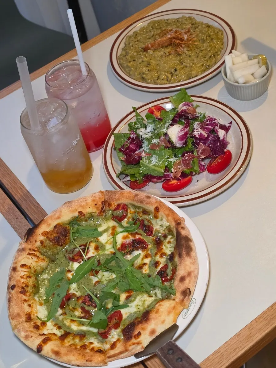 A slice of basil margherita pizza with grilled crust