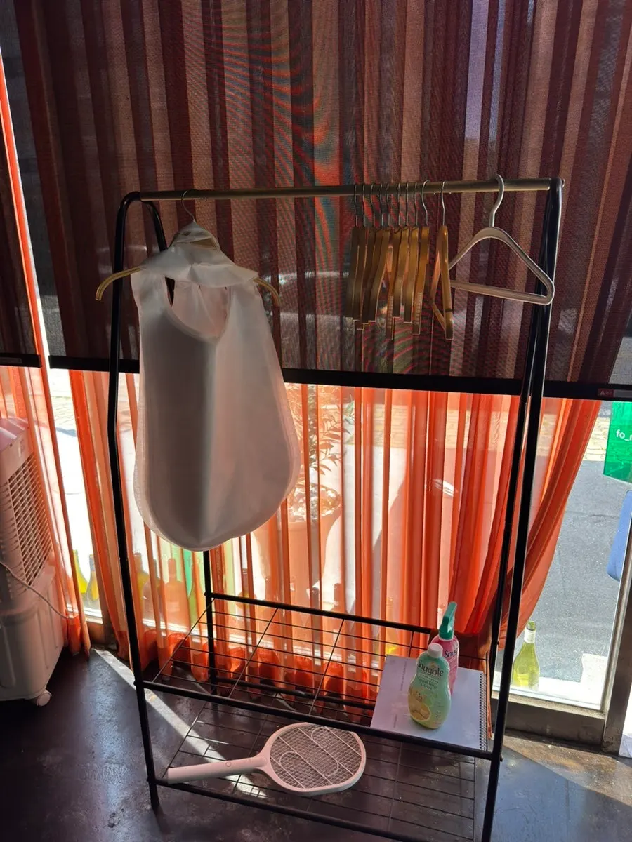 Coat rack and Febreze at the Suwanjigu Form entrance