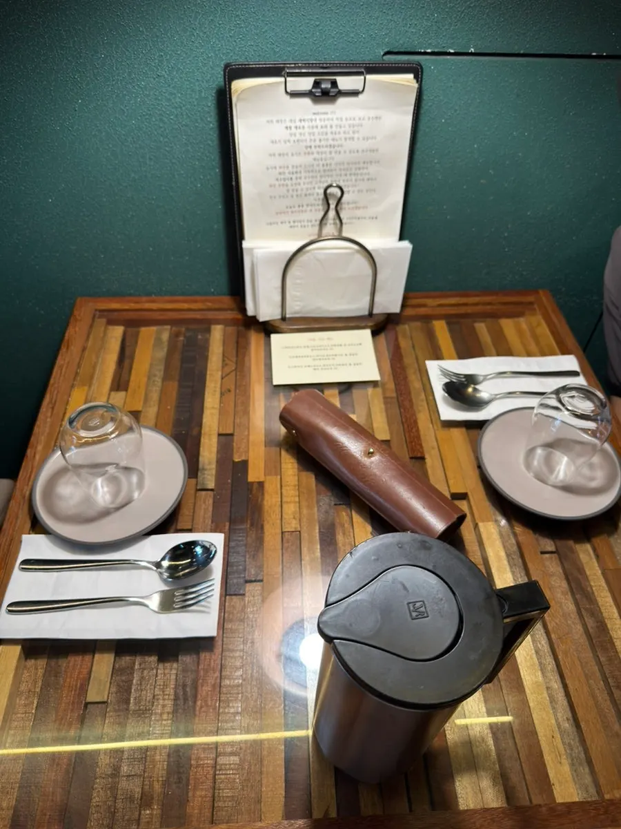 Table for two set with cutlery and water glasses