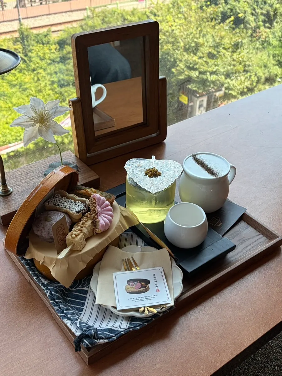 Table of drinks and desserts by the ocean-view window