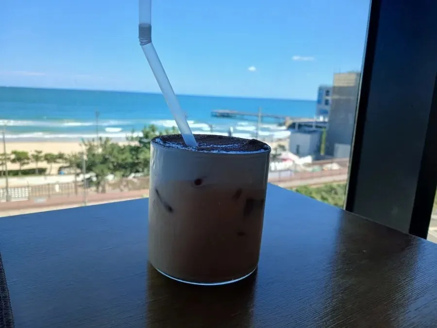 Drink glass by the window overlooking the Songjeong sea