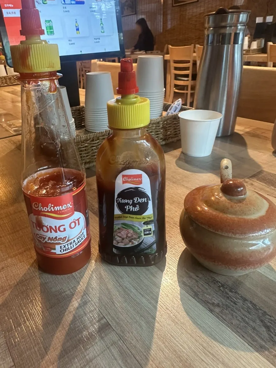 Peanut sauce, spicy sauce, and pickled garlic side by side
