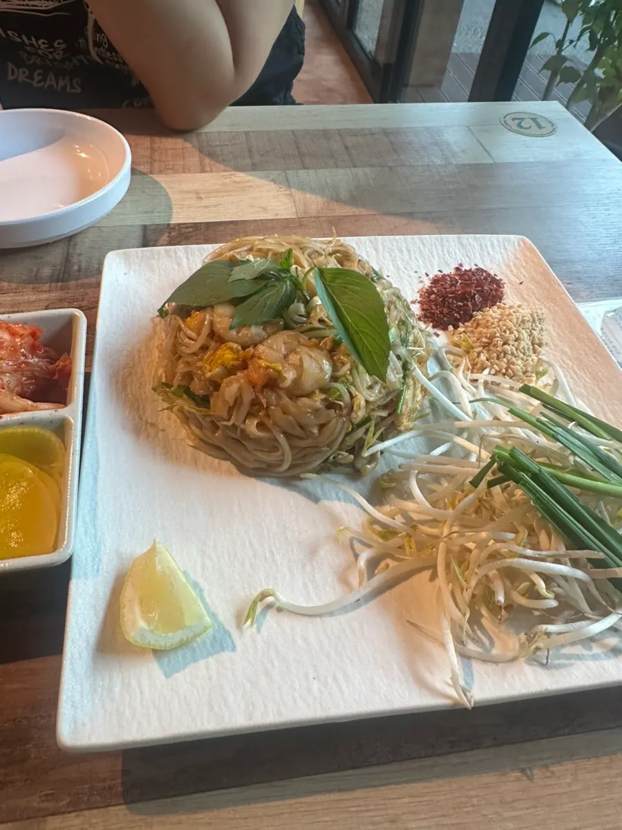 Pad thai served with bean sprouts and chives