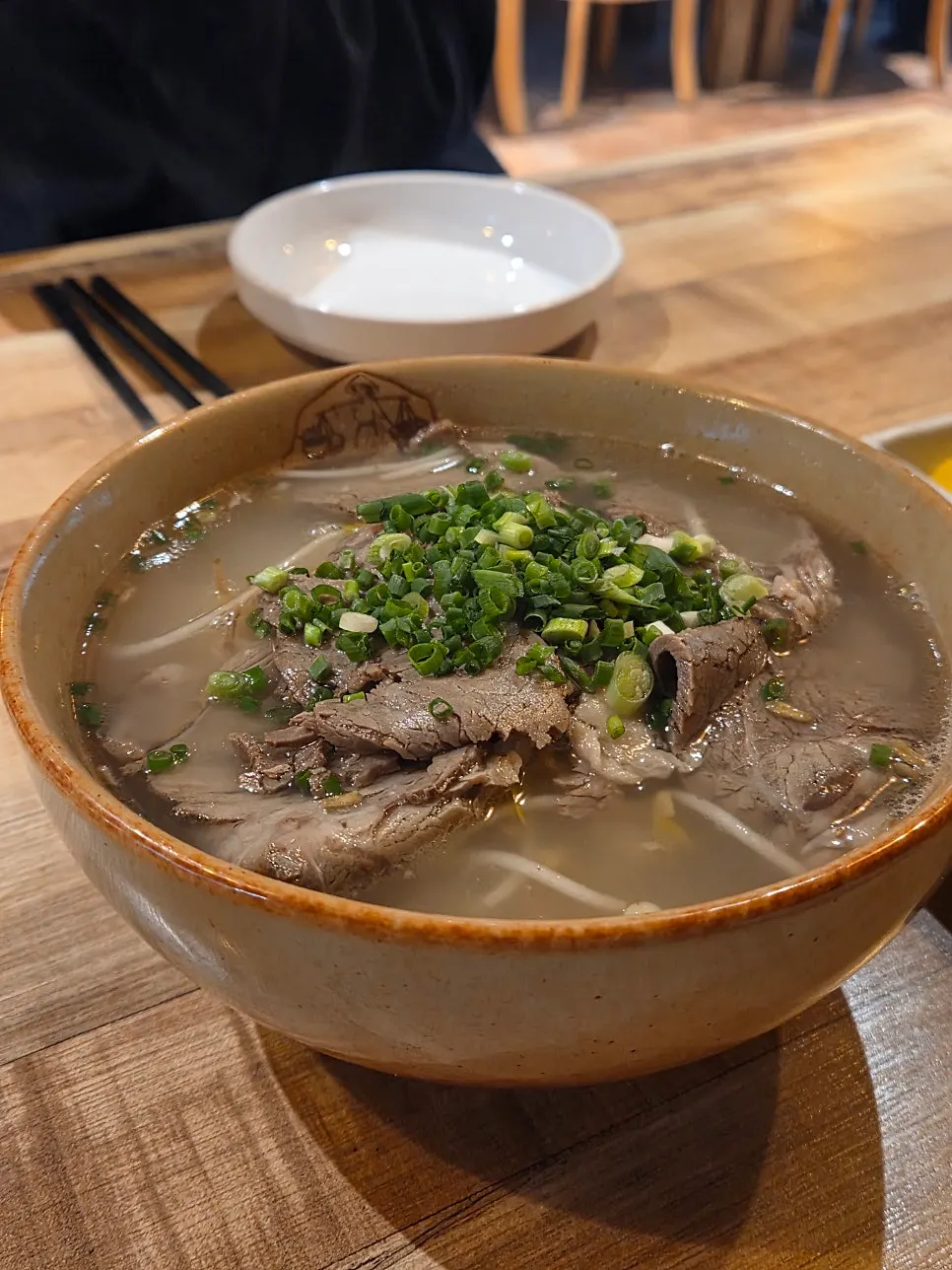 Close-up of the clear broth in the beef brisket pho