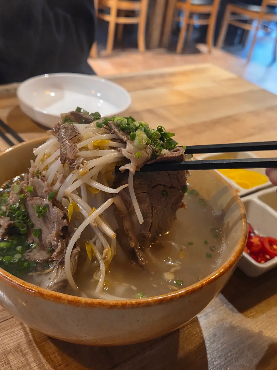 Beef brisket slices on top of the pho