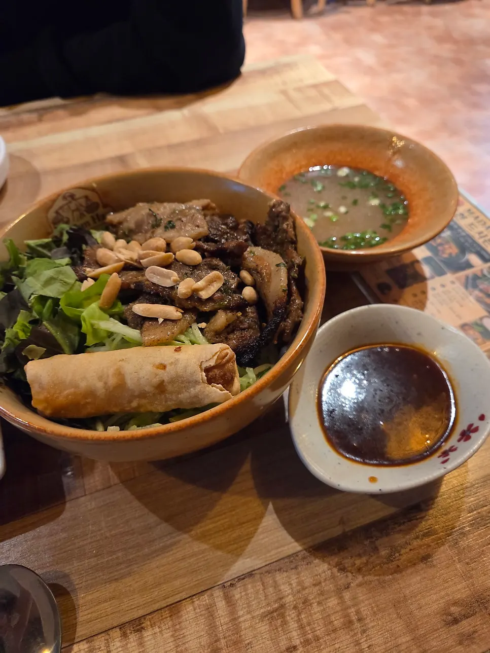 Table setting with both the beef brisket pho and bulgogi bibim guksu