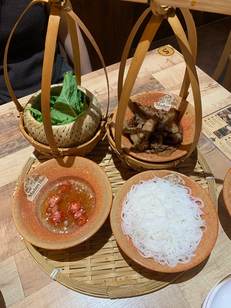 Table setting with both beef brisket pho and bun cha