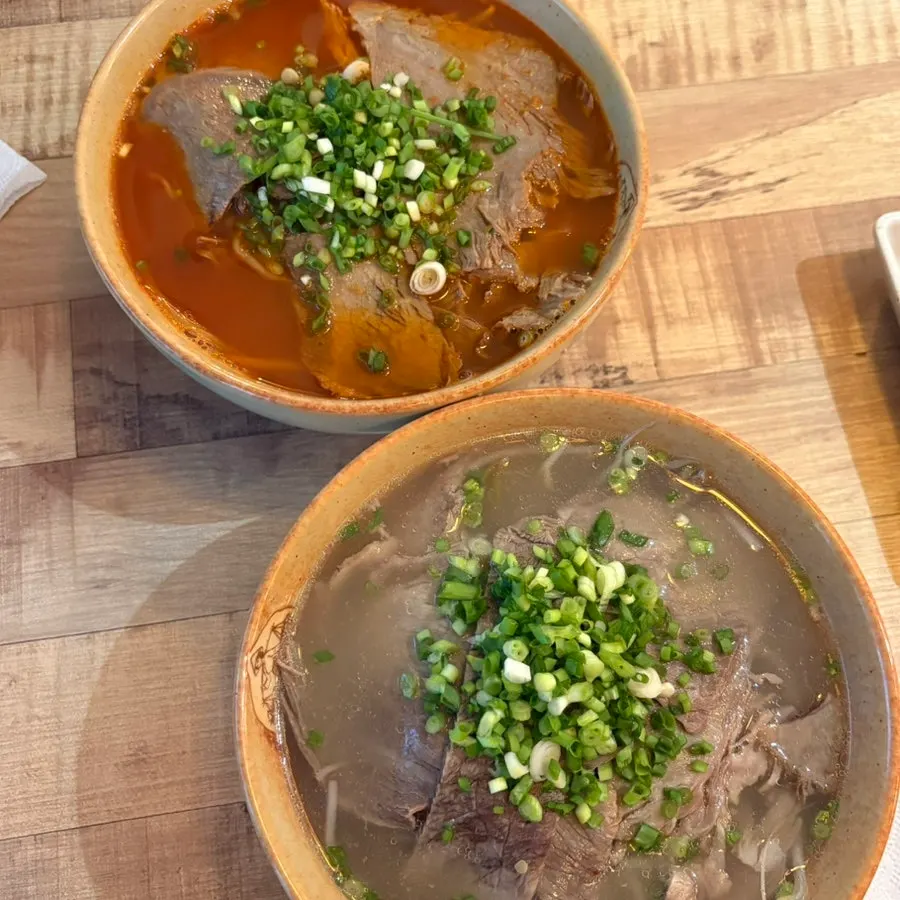 Table setting with two bowls of pho at Madam Hao