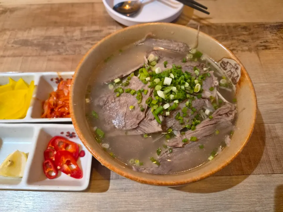 A forkful of noodles lifted from the beef brisket pho