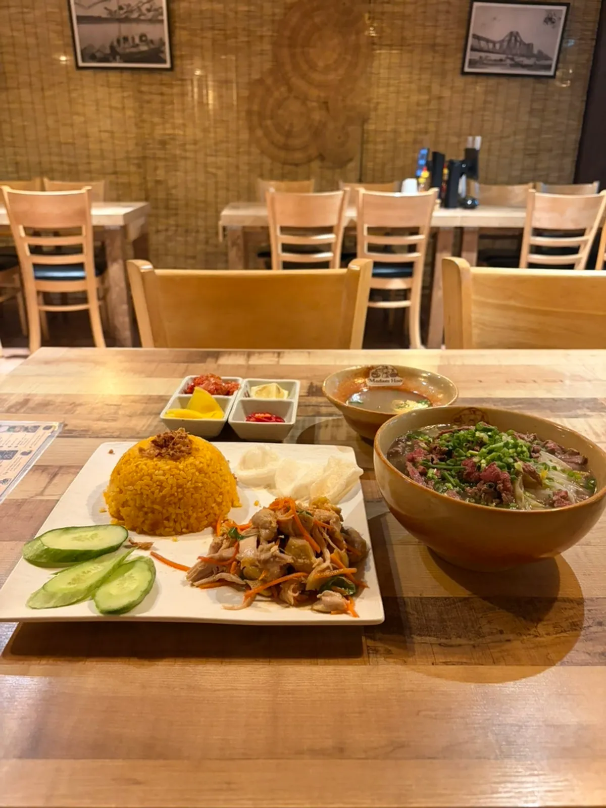 Table setting with pad Thai and chicken rice bowl